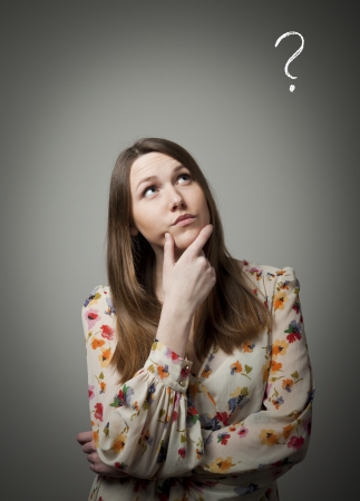 Young woman and question mark above headの写真素材