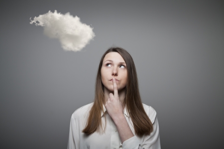 Girl and cloud. Girl thinking. Imagination concept.の写真素材