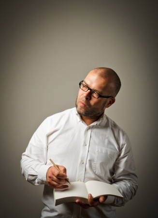 Man in white is ready to write something.の写真素材