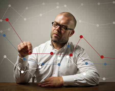 Man in white  Businessman is showing an increasing graph of something の写真素材