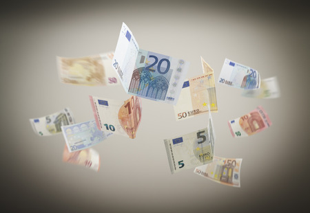Falling Euro on the grey background.の写真素材
