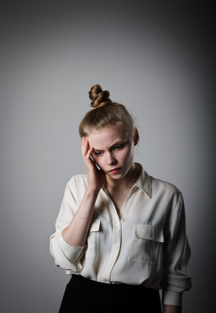 Sad young woman. Sorrow. Young slim woman.の写真素材
