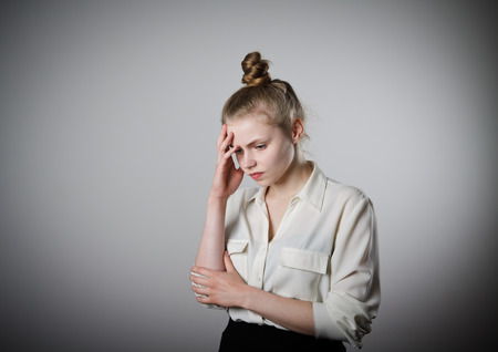 Sad young woman. Sorrow. Young slim woman.の写真素材