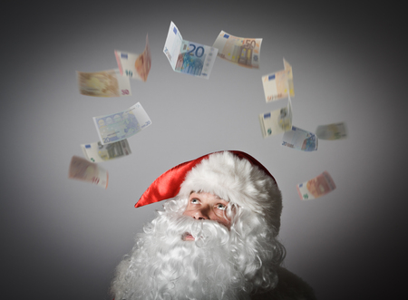 Santa Claus and falling Euro banknotes. Currency and lottery concept.の写真素材