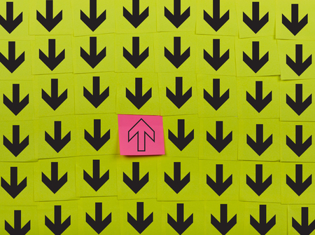 Arrows. Opposite direction concept. Background of green sticky notes.の写真素材