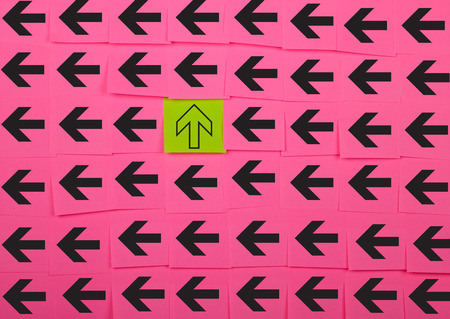Arrows. Vertical and horizontal concept. Background of pink sticky notes.の写真素材