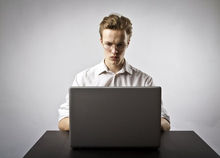 Young man using a laptop to browse the net.の写真素材