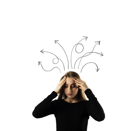 Frustrated young woman in black isolated on white background. Expressions, feelings and moods. Woman solving a problem. Arrows over her head.の写真素材
