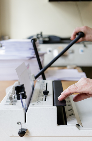 Book Binding Machine Operator. Book binding machine.  Work with Book binding machine. Printing equipment.の写真素材