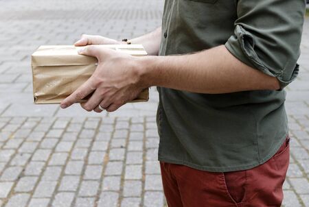 Package delivery. Delivery man is holding packaging or cardboard boxes. Delivery man at work.の写真素材