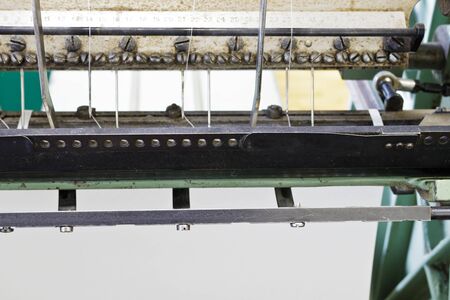 Machine for stitching book pages. The elements of the machine for stitching book pages with threads in typography.の写真素材