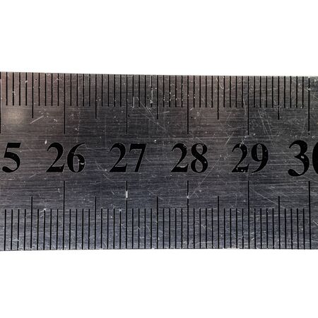Metal ruler with digits and scale isolated on white background. Macro.の写真素材