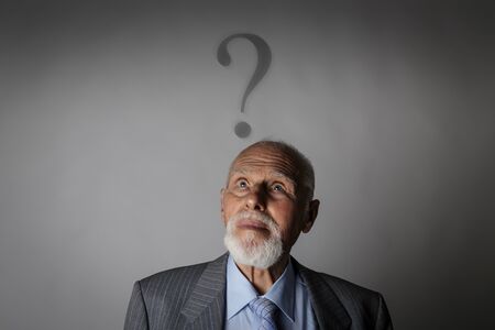 Old man is full of doubts and hesitation. Old man and question mark above head.