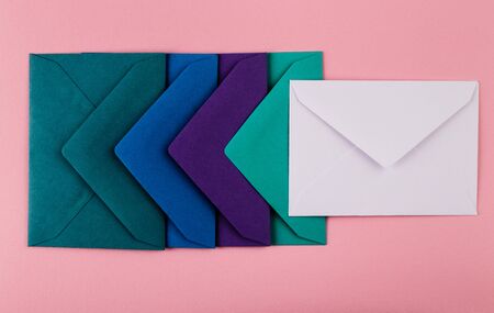 Mail envelopes on color background. Different colored envelopes on the table.