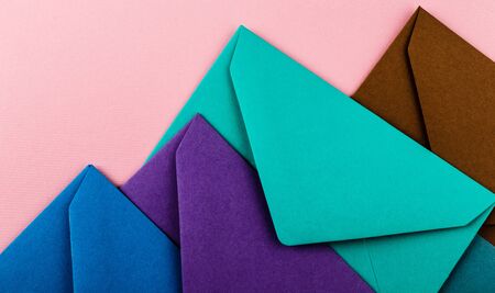 Mail envelopes on color background. Different colored envelopes on the table.