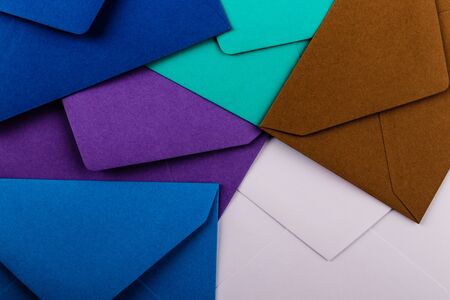 Mail envelopes on color background. Different colored envelopes on the table.の写真素材
