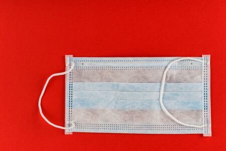 Medical protective mask on red background. Surgical face mask. coronavirus outbreak concept.