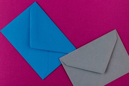 Colorful envelopes on a purple background. Mail envelopes on the table.