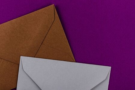 Colorful envelopes on a purple background. Mail envelopes on the table.の写真素材