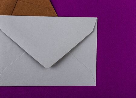 Colorful envelopes on a purple background. Mail envelopes on the table.の写真素材