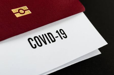 Coronavirus and travel concept. Passport and note COVID-19. Border control and quarantine of...