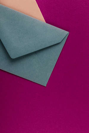 Colorful envelopes on a purple background. Mail envelopes on the table.の写真素材