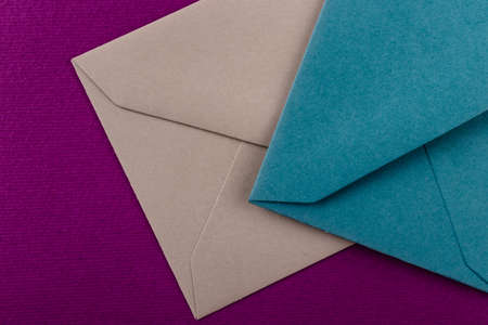 Colorful envelopes on a purple background. Mail envelopes on the table.の写真素材