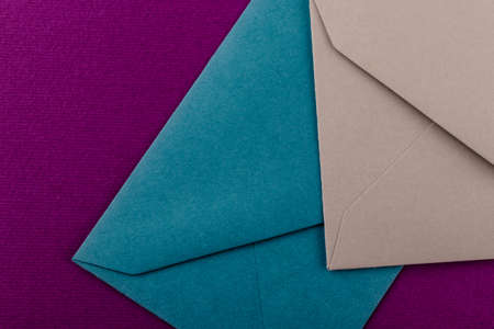 Colorful envelopes on a purple background. Mail envelopes on the table.の写真素材