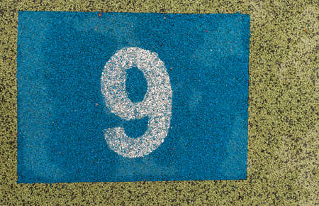 Hopscotch in a schoolyard. Detail of jumping hopscotch game with number. Summer activities for children. Number nine.の写真素材