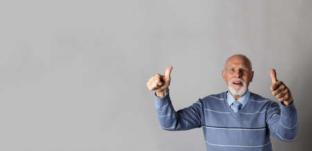 Old man is showing thumbs up.の写真素材