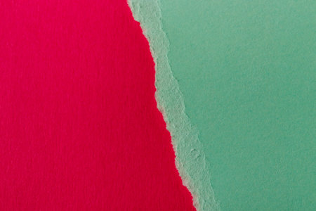 Ripped paper, space for copy. Torn green paper on red background. Textures.の写真素材