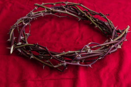 Crown of thorns on red background. Easter symbol with copy space.の写真素材