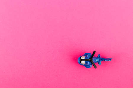 Small plastic helicopter with copy space on pink background. Toy.の写真素材