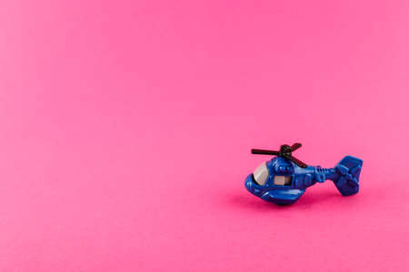 Small plastic helicopter with copy space on pink background. Toy.の写真素材