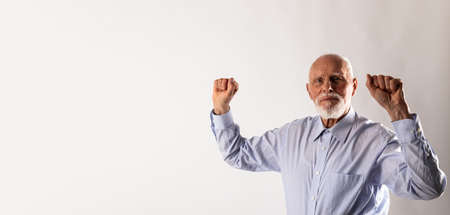 Rejoicing old man. Success concept. Raised hands.