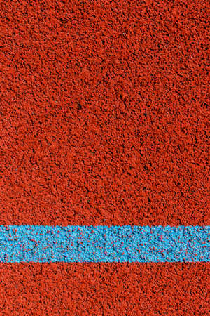 Basketball court lines. Top view to brown field rubber ground with white lines.