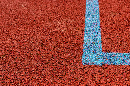 Basketball court lines. Brown field rubber ground with blue lines.の写真素材