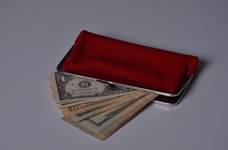 Us dollar bills in a red women walletの写真素材