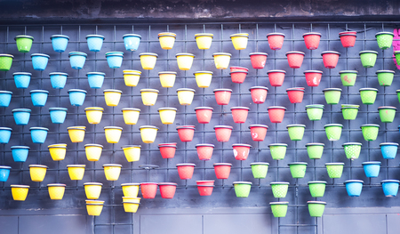 row of clay colorful pot on the wall .の写真素材
