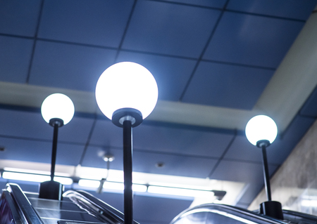Fluorescent round lamps line at metro station