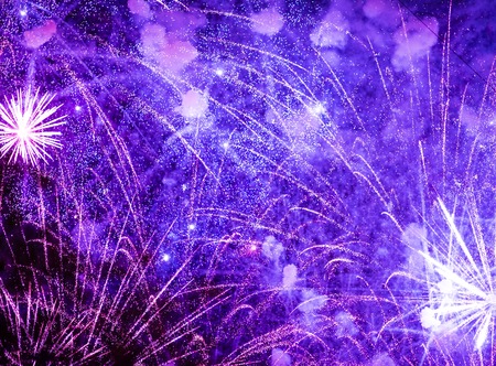 Salute in the night sky. Bright texture of festive fireworks. Abstract holiday background with various colors fireworks light. New Years, Christmas lights in the sky, colorful lights.の写真素材