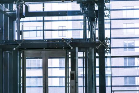 Modern elevator made of steel and transparent glass.