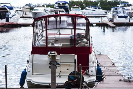 Small motor boat at anchor by rope in Replot pierの写真素材