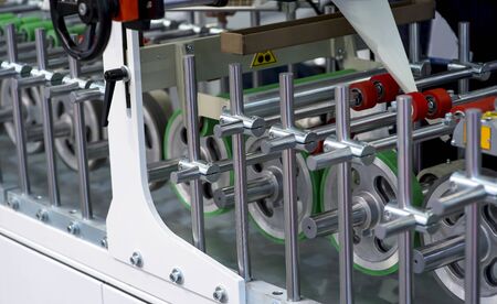 Conveyor belt of packaging folding machine at print factory.