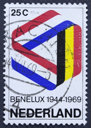 NETHERLANDS - CIRCA 1969  a stamp printed in the Netherlands shows Mobius Strip in Benelux Colors, 25th Anniversary of the Signing of the Customs Union, circa 1969 の写真素材