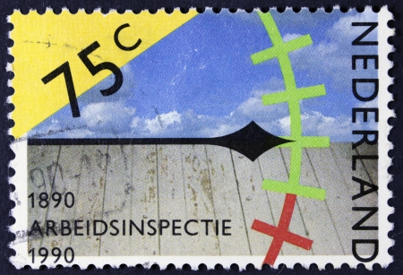 NETHERLANDS - CIRCA 1989  a stamp printed in the Netherlands shows Clock, Sky and Wooden Floor, Assessing Work Conditions, Centenary of Labor Inspectorate, circa 1989 のeditorial素材