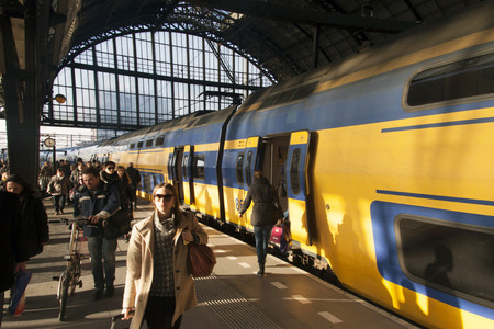 Amsterdam, Holland - february 4.2014: Just arrived dutch ns train with passengers alighting on Amsterdam central station.のeditorial素材