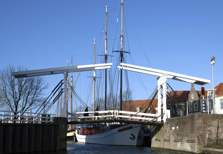 Old white wooden bridge in the center of the Dutch city Enkhuizenの写真素材