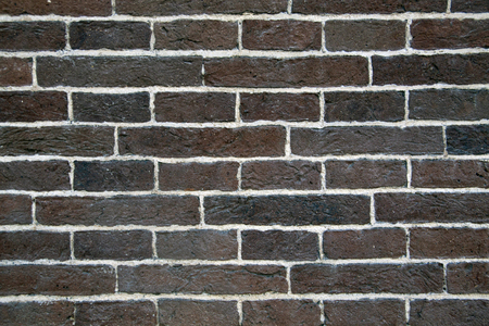 Old brick wall with white joints between the bricksの写真素材