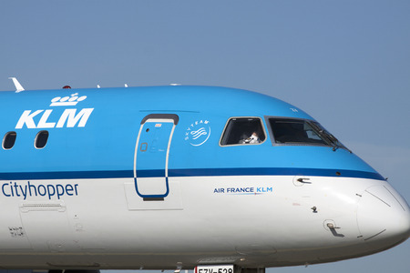 AMSTERDAM, THE NETHERLANDS - March 11, 2015: Close up photo of the cabin of a klm cityhopper aircraft, with the pilot behind the window. On March 11, 2015 in Amsterdam, Holland.のeditorial素材